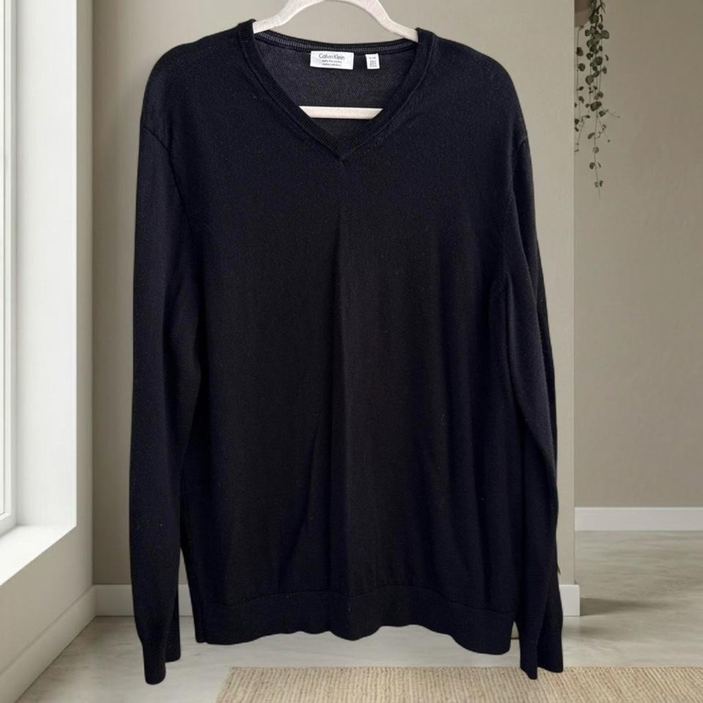 100% merino wool Calvin Klein Black v-neck sweater with a relaxed fit